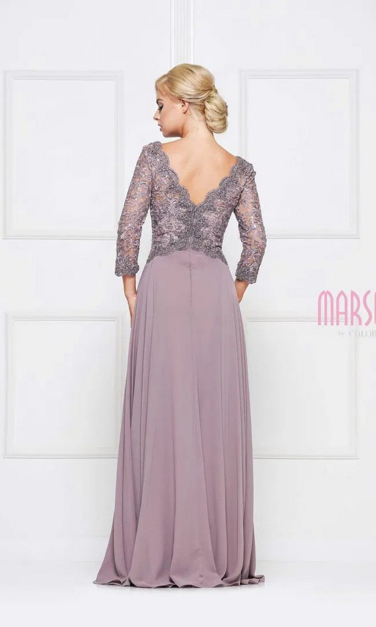 A woman faces away from the camera in front of white paneled doors, showcasing the Marsoni M225 long formal dress with a mauve lace-embroidered bodice, three-quarter sleeves, V-back, and flowing chiffon A-line skirt.